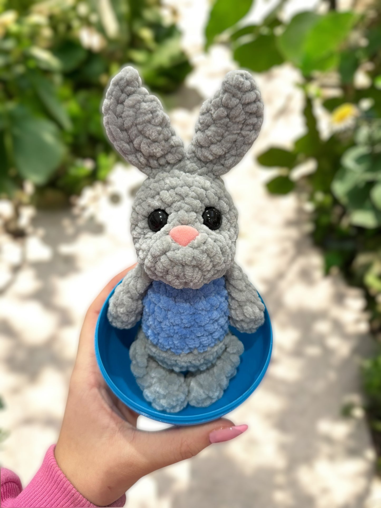 Grey bunny in blue egg