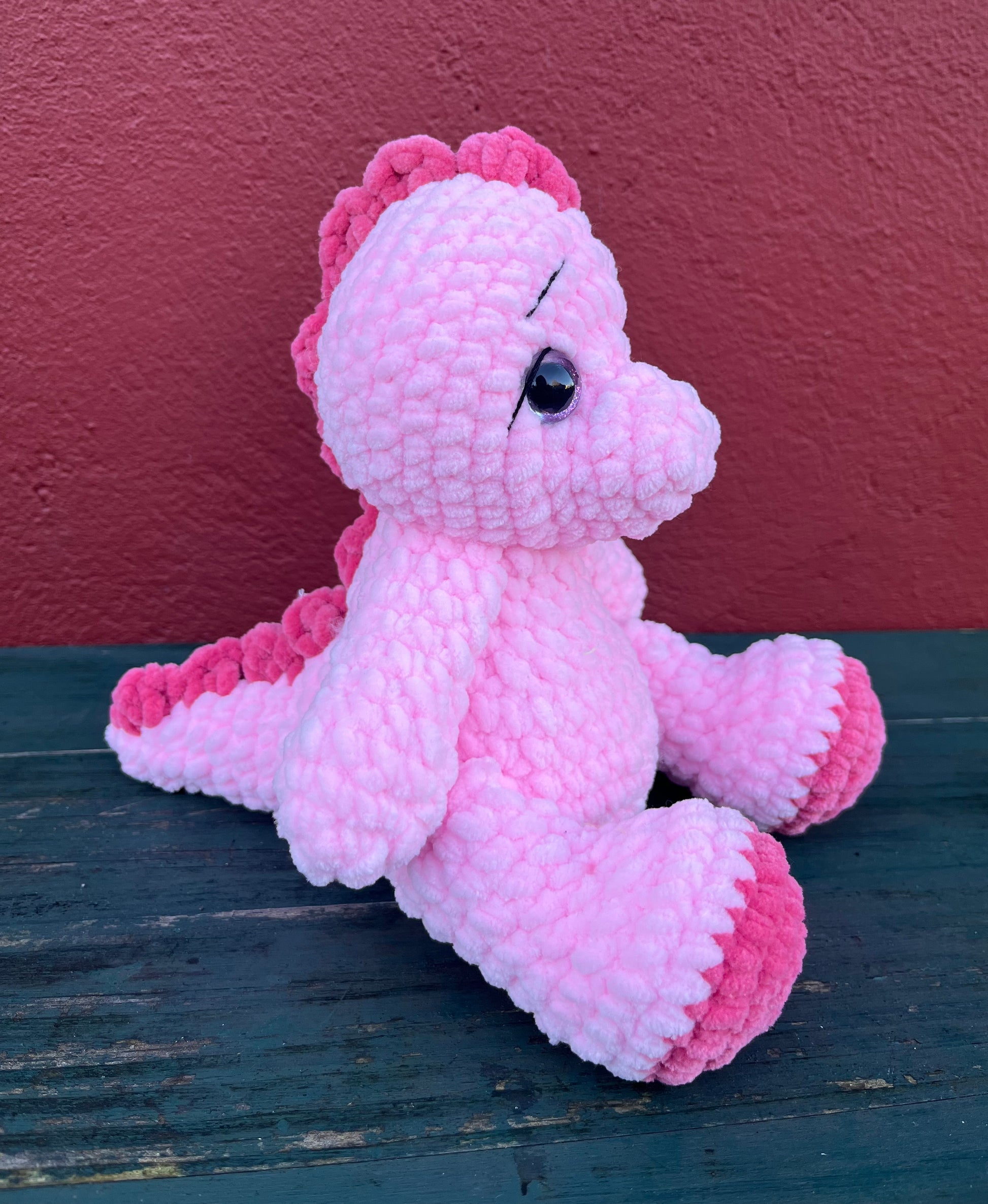 pink dinosaur sitting