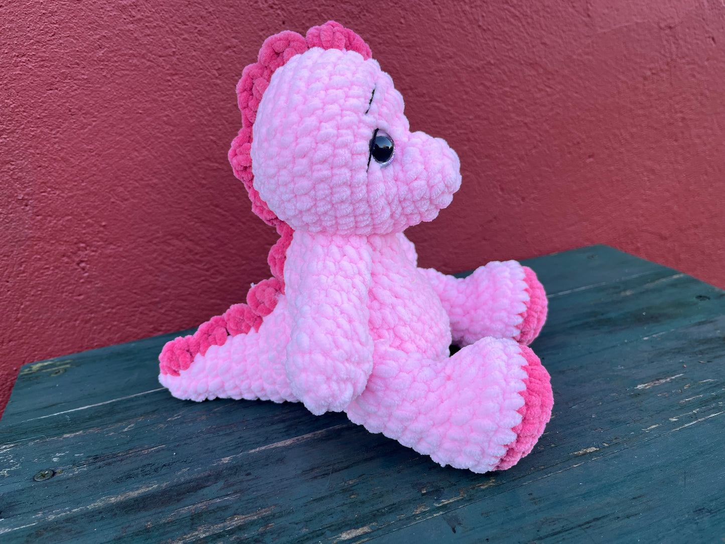 pink dinosaur sitting